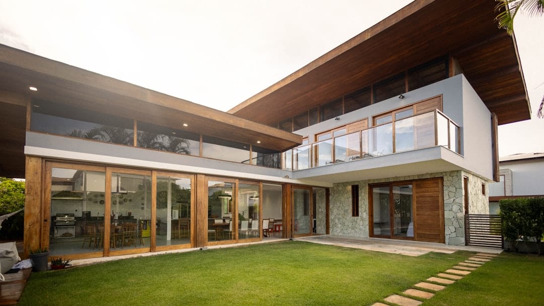 Modern house with large windows and a green lawn